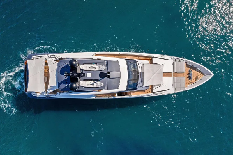 Slide: The Image of Aerial view of 2024 Custom Line 106 yacht cruising on clear blue water. - 9