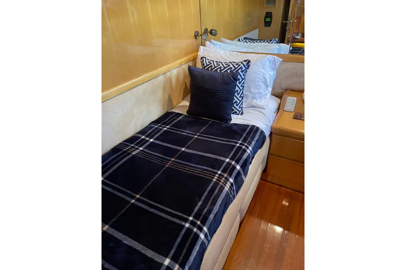 Slide: The Image of Wooden nightstand with phone, remote, and outlets on Johnson 65 Flybridge Motoryacht, 1995. - 102