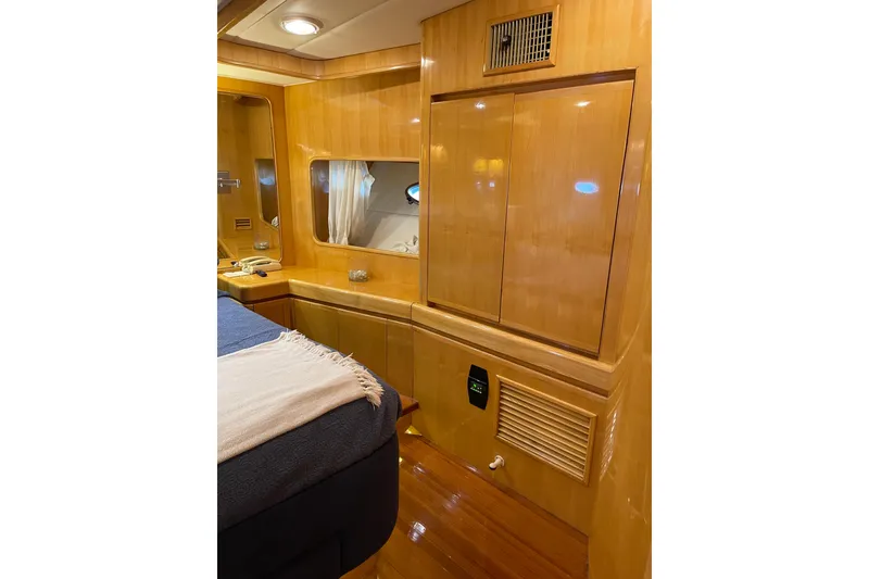 Slide: The Image of Interior of 1995 JOHNSON 65 Flybridge Motoryacht with wooden paneling and porthole windows. - 105