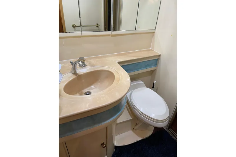 Slide: The Image of Interior of 1995 JOHNSON 65 Flybridge Motoryacht, featuring a bathroom and wooden steps. - 108