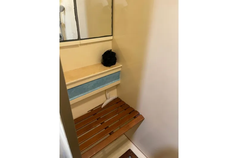 Slide: The Image of Luxurious interior of 1995 JOHNSON 65 Flybridge Motoryacht with wood paneling and cozy bedding. - 110