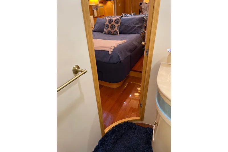 Slide: The Image of Luxurious bedroom interior of 1995 JOHNSON 65 Flybridge Motoryacht with elegant wood paneling. - 111