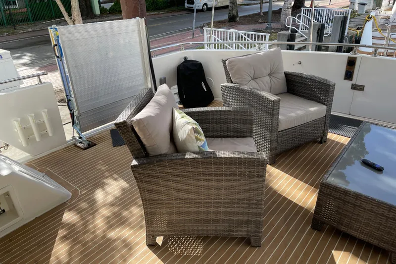 Slide: The Image of 1995 JOHNSON 65 Flybridge Motoryacht docked with inflatable boat attached. - 12