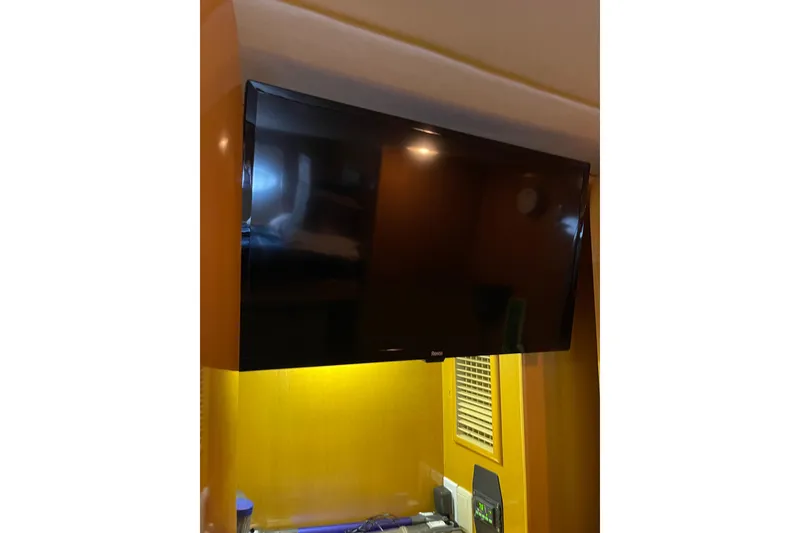 Slide: The Image of Interior of 1995 JOHNSON 65 Flybridge Motoryacht with wooden paneling and bathroom access. - 120