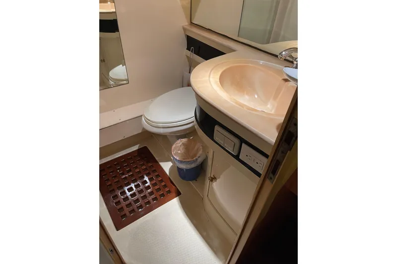 Slide: The Image of Interior of 1995 JOHNSON 65 Flybridge Motoryacht with open wooden cabinet. - 121
