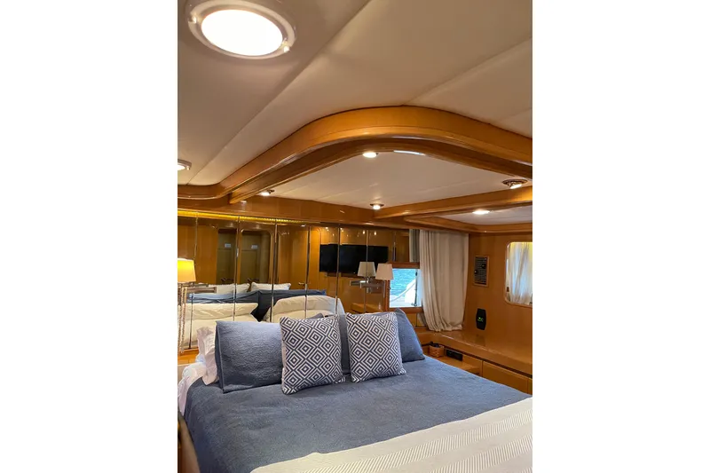 Slide: The Image of Illuminated wooden staircase inside 1995 JOHNSON 65 Flybridge Motoryacht, leading to upper deck. - 128