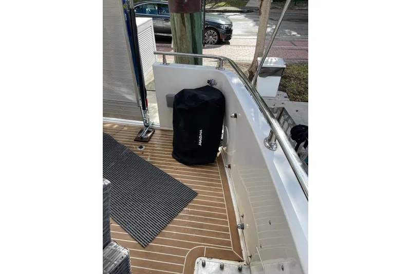 Slide: The Image of Outdoor seating area on 1995 JOHNSON 65 Flybridge Motoryacht with wicker furniture and cushions. - 15