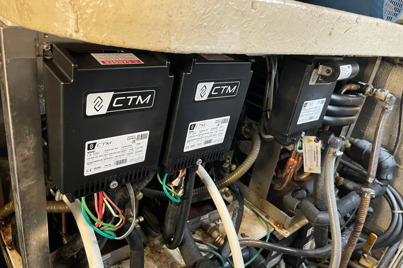 Slide: The Image of Engine room of 1995 JOHNSON 65 Flybridge Motoryacht, showcasing detailed machinery components. - 156