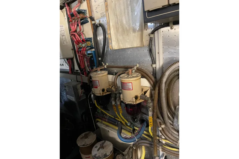 Slide: The Image of Engine room of 1995 JOHNSON 65 Flybridge Motoryacht with fuel filters and hoses. - 166