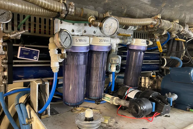 Slide: The Image of Engine room of 1995 Johnson Flybridge Motoryacht with water filtration system and gauges. - 169