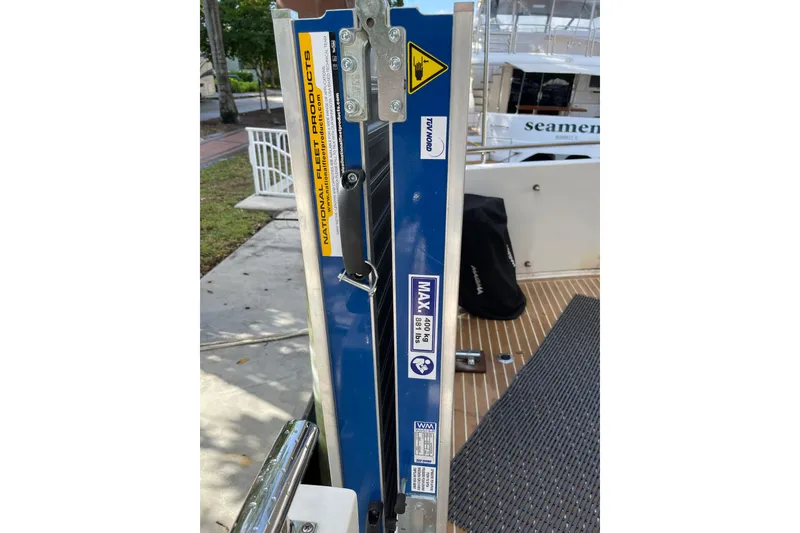 Slide: The Image of 1995 JOHNSON 65 Flybridge Motoryacht deck with covered equipment and wooden flooring. - 17