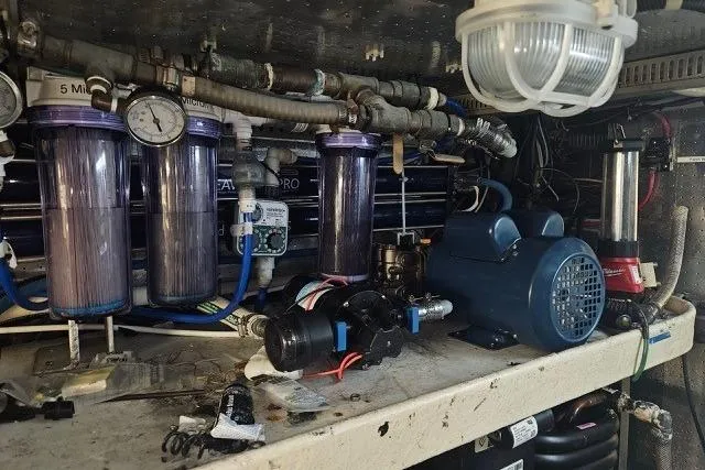 Slide: The Image of Engine room of a 1995 Johnson Flybridge Motoryacht with filtration system and machinery. - 170