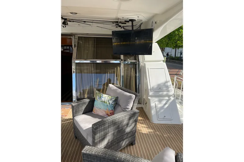 Slide: The Image of 1995 JOHNSON 65 Flybridge Motoryacht deck with metal gate and wooden flooring. - 18