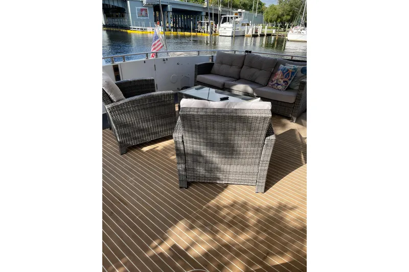 Slide: The Image of Luxurious 1995 JOHNSON 65 Flybridge Motoryacht with cozy seating and mounted TV. - 21