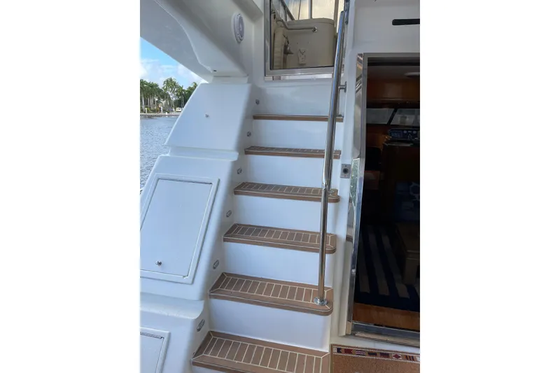Slide: The Image of Outdoor seating on 1995 JOHNSON 65 Flybridge Motoryacht, featuring wicker furniture and waterfront view. - 25