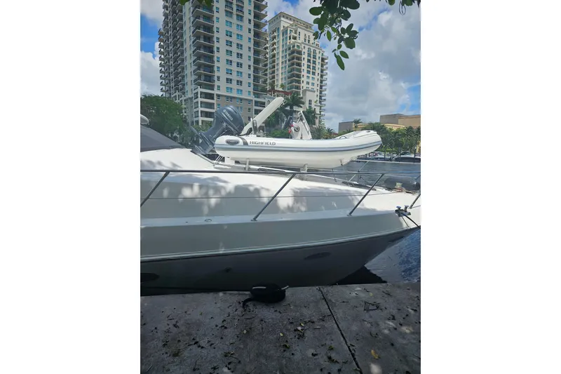 Slide: The Image of 1995 JOHNSON 65 Flybridge Motoryacht docked near high-rise buildings. - 4