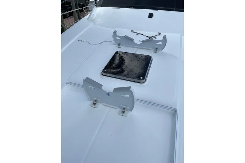 Slide: The Image of 1995 JOHNSON 65 Flybridge Motoryacht with life raft on deck, docked near marina. - 48