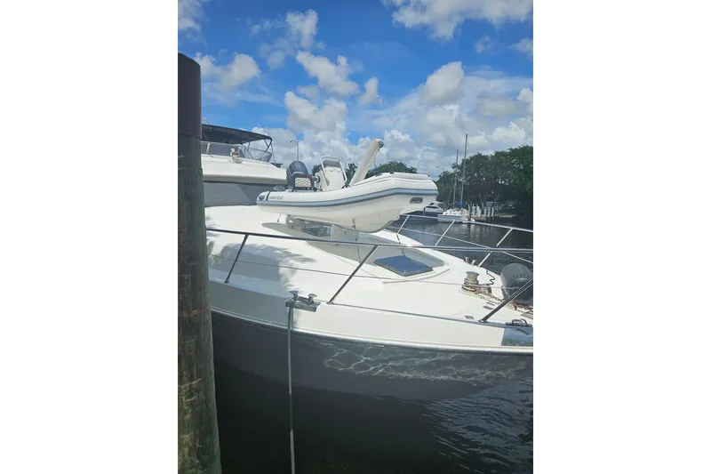 Slide: The Image of 1995 JOHNSON 65 Flybridge Motoryacht docked under blue sky. - 5