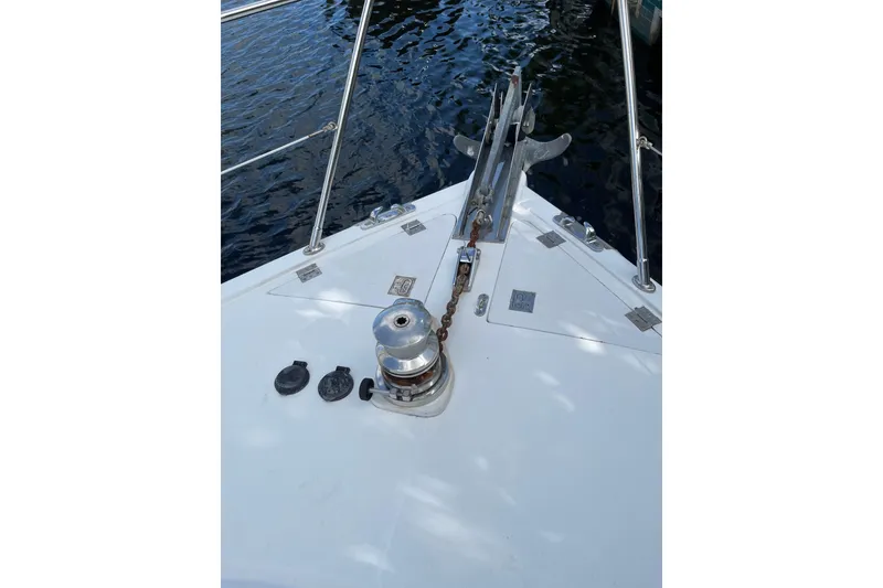 Slide: The Image of Flybridge of 1995 JOHNSON 65 Motoryacht with Steelhead Marine crane, docked by the water. - 50