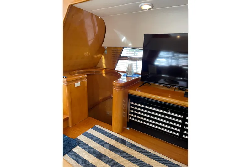 Slide: The Image of Interior of 1995 JOHNSON 65 Flybridge Motoryacht with cozy seating and nautical decor. - 63
