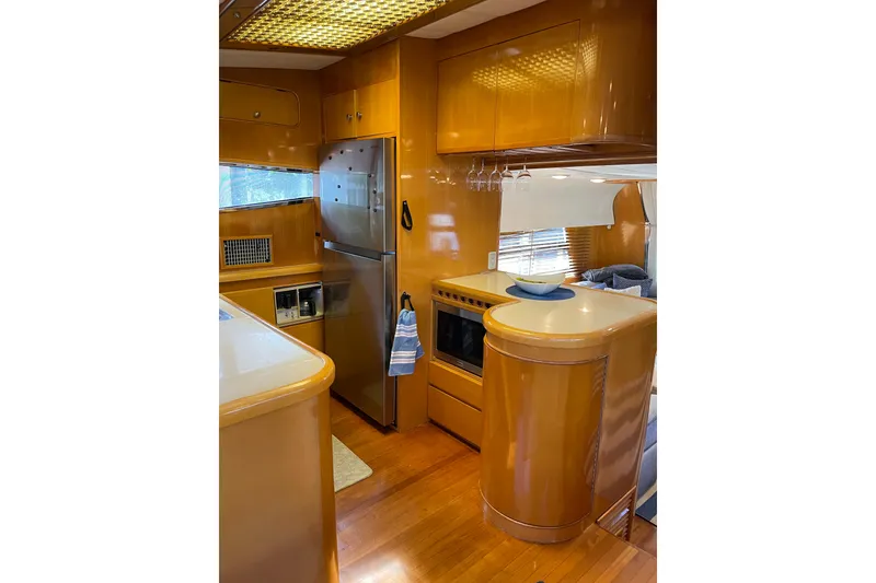 Slide: The Image of Interior of 1995 JOHNSON 65 Flybridge Motoryacht with wooden finishes and cozy seating area. - 66