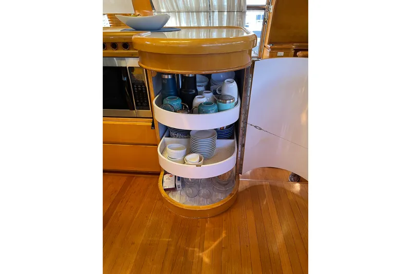 Slide: The Image of Luxurious 1995 JOHNSON 65 Flybridge Motoryacht interior with cozy seating and elegant wood finish. - 69