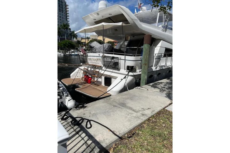 Slide: The Image of 1995 JOHNSON 65 Flybridge Motoryacht docked at marina, rear view. - 7