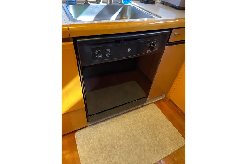 Slide: The Image of Luxurious interior of 1995 JOHNSON 65 Flybridge Motoryacht with wooden finishes and cozy seating. - 70