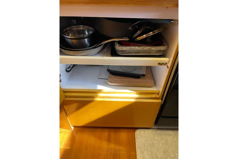 Slide: The Image of Luxurious 1995 JOHNSON 65 Flybridge Motoryacht kitchen with wood cabinetry and modern appliances. - 71