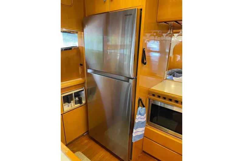 Slide: The Image of Open cabinet with dishes and cups on a Johnson 65 Flybridge Motoryacht, 1995 model. - 74