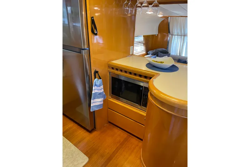 Slide: The Image of Kitchen area with dishwasher and sink on a 1995 JOHNSON 65 Flybridge Motoryacht. - 75