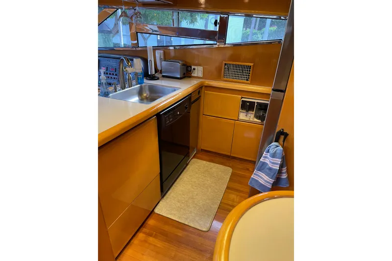 Slide: The Image of Kitchen cabinet with cookware and utensils on a 1995 JOHNSON 65 Flybridge Motoryacht. - 76