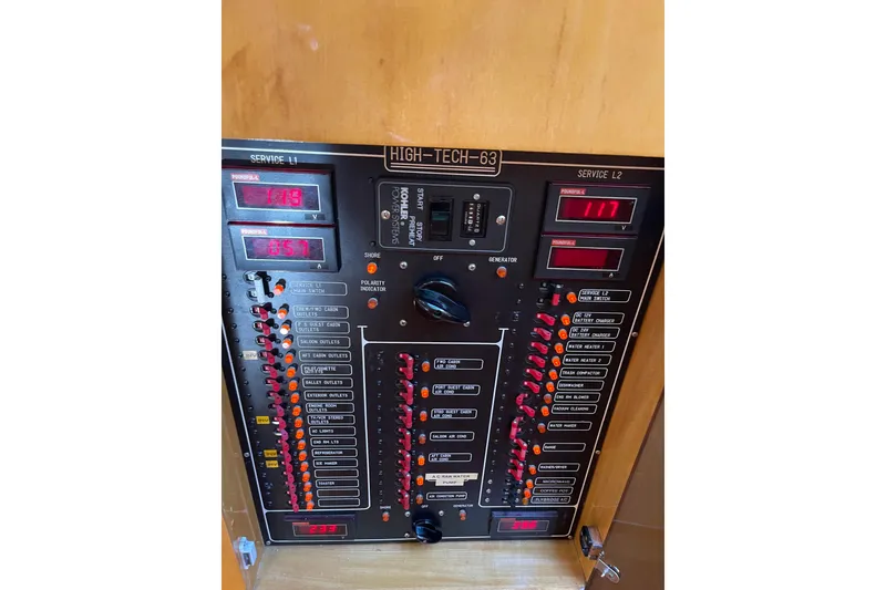 Slide: The Image of Electrical control panel on a 1995 JOHNSON 65 Flybridge Motoryacht, featuring switches and indicators. - 92