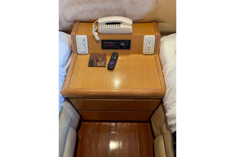 Slide: The Image of Interior of 1995 JOHNSON 65 Flybridge Motoryacht with textured wall and wooden seat. - 97