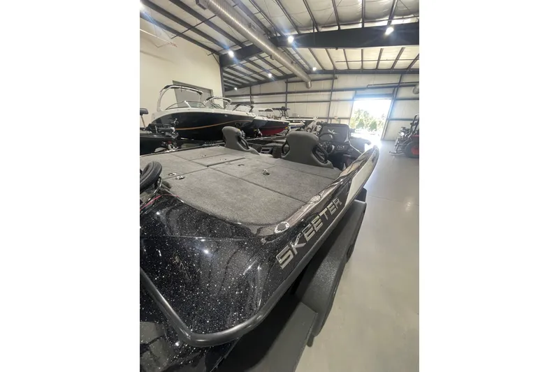 Slide: The Image of 2026 Skeeter ZXR20 SE boat in showroom, featuring sleek design and spacious deck. - 14