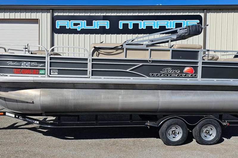 The Image of 2016 Sun Tracker Fishin' Barge 22 DLX pontoon boat on trailer at Aqua Marine. - 0