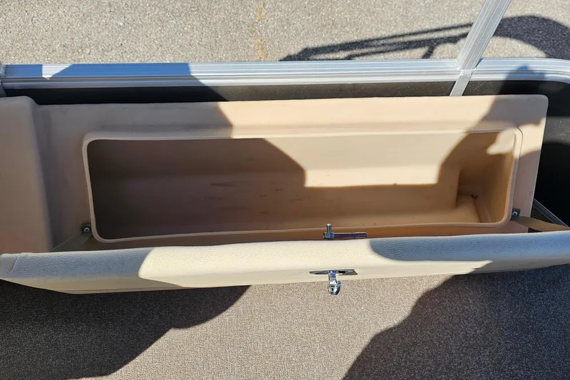 Slide: The Image of Storage compartment on 2016 Sun Tracker Fishin' Barge 22 DLX boat, open and empty. - 18