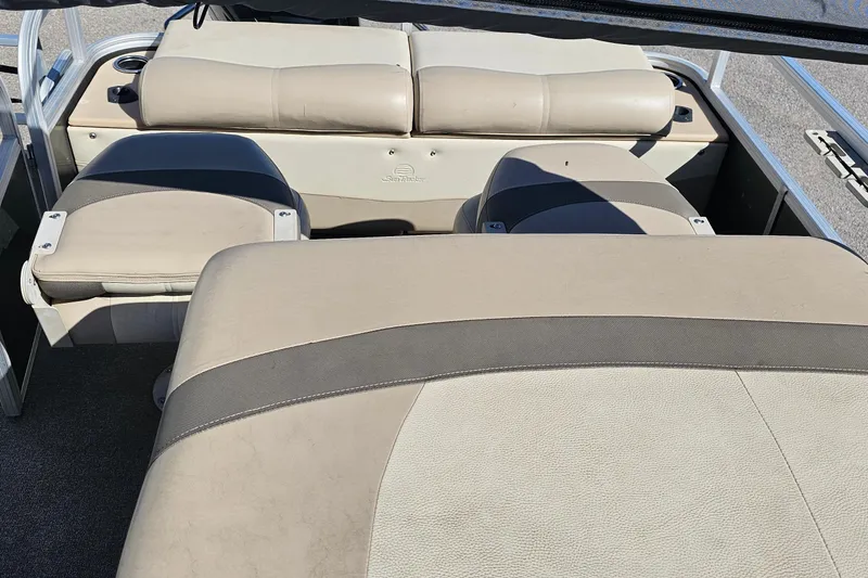 Slide: The Image of 2016 Sun Tracker Fishin' Barge 22 DLX interior seating, beige upholstery, spacious layout. - 20