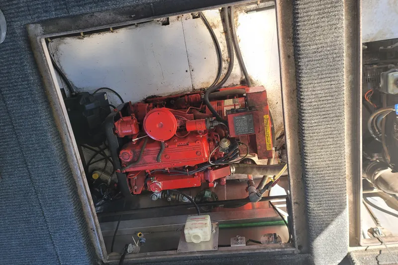 Slide: The Image of Engine compartment of a 2002 Fantasy 16 X 68 Houseboat, featuring a red engine. - 15