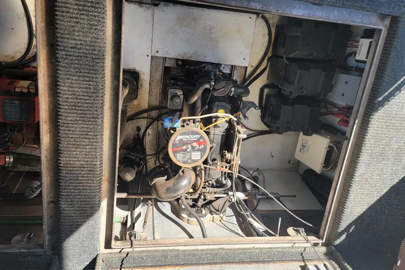 Slide: The Image of Engine compartment of a 2002 Fantasy 16 X 68 Houseboat, featuring a Mercury Marine engine. - 16