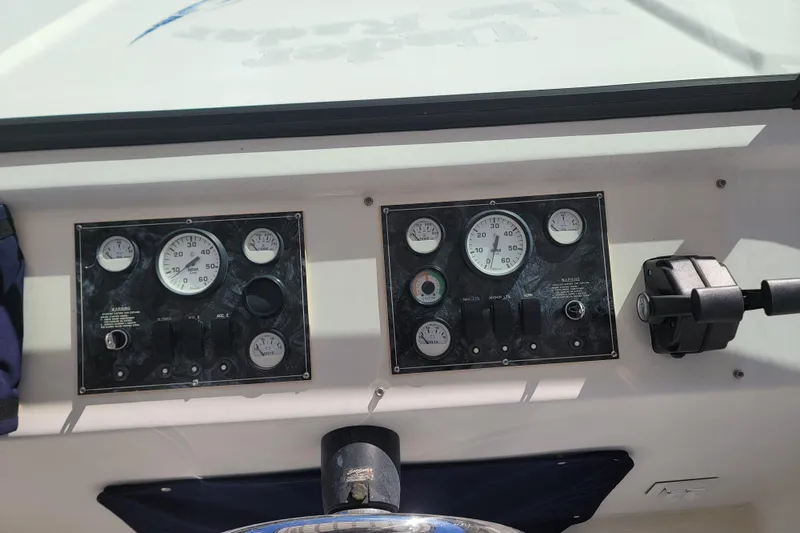 Slide: The Image of Control panel of a 2002 Fantasy 16 X 68 Houseboat with gauges and switches. - 18
