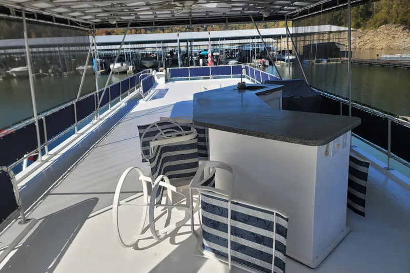 Slide: The Image of 2002 Fantasy 16 X 68 Houseboat with spacious deck and seating area at marina. - 20