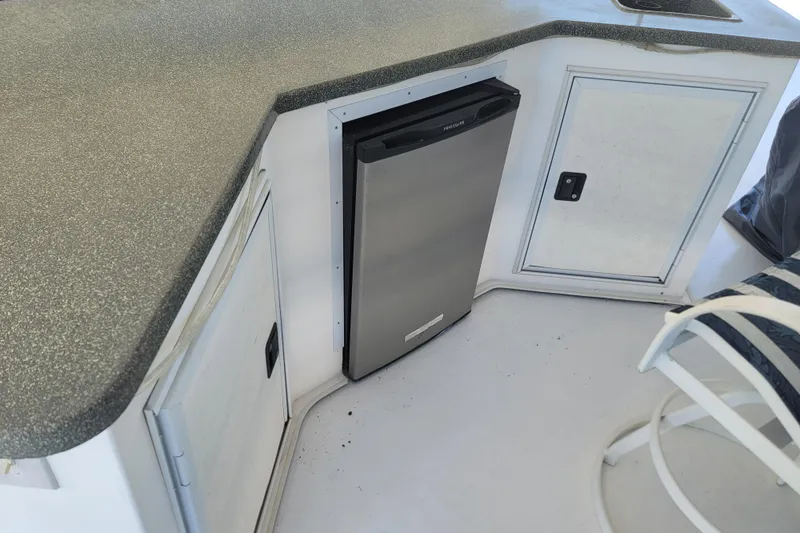 Slide: The Image of Compact kitchen area on a 2002 Fantasy 16 X 68 houseboat with mini fridge and cabinets. - 21