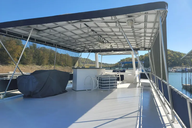 Slide: The Image of 2002 Fantasy 16 X 68 Houseboat with covered deck on a sunny lake. - 24