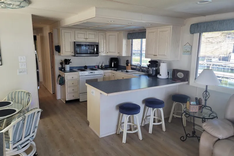 Slide: The Image of Interior of 2002 Fantasy 16 X 68 houseboat kitchen with bar stools and modern appliances. - 25