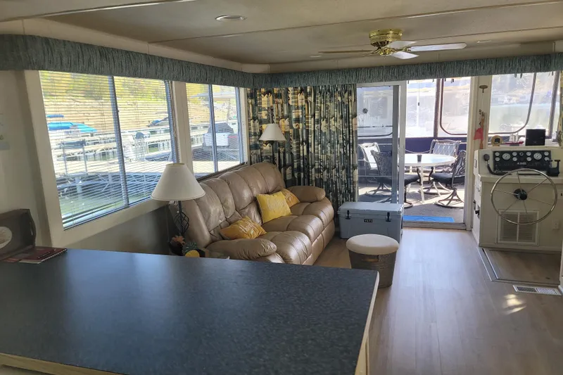 Slide: The Image of Interior of a 2002 Fantasy 16 X 68 Houseboat with cozy seating and large windows. - 28