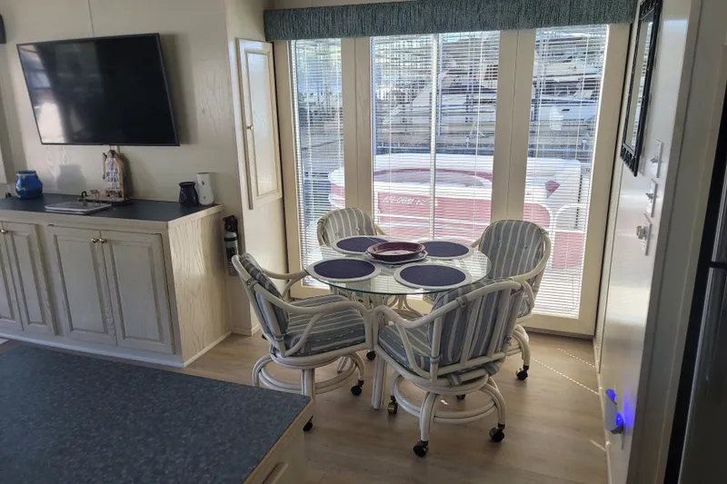 Slide: The Image of Interior of 2002 Fantasy 16 X 68 Houseboat with dining area and TV. - 29