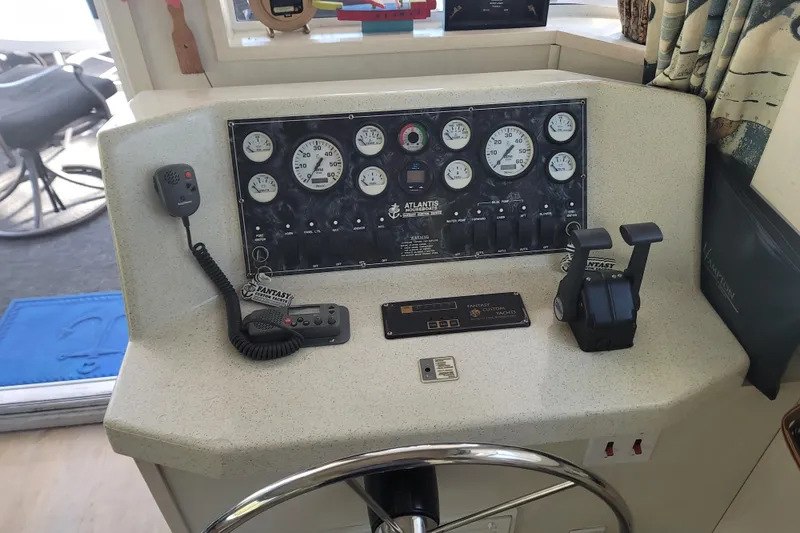 Slide: The Image of Control panel of a 2002 Fantasy 16 X 68 Houseboat with gauges and communication devices. - 30