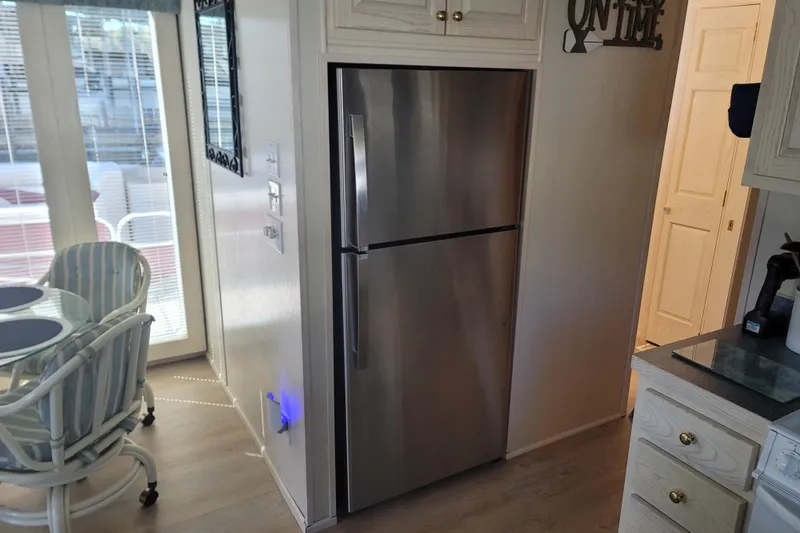 Slide: The Image of Modern kitchen in 2002 Fantasy 16 X 68 houseboat with stainless steel fridge. - 33