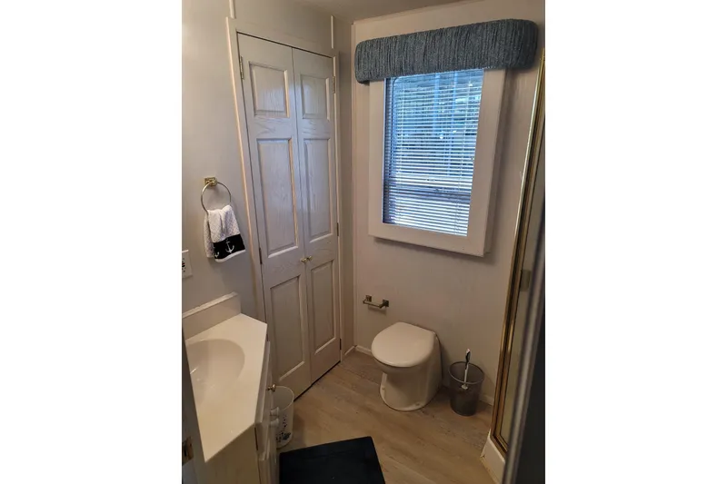 Slide: The Image of Small bathroom in 2002 Fantasy 16 X 68 houseboat with window, toilet, and sink. - 36